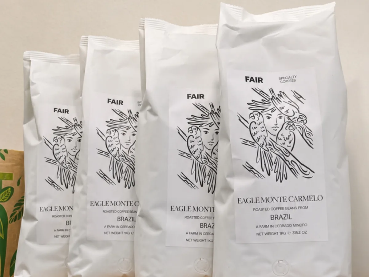 Bags of specialty coffee lined up on the shelf at Upendo.
