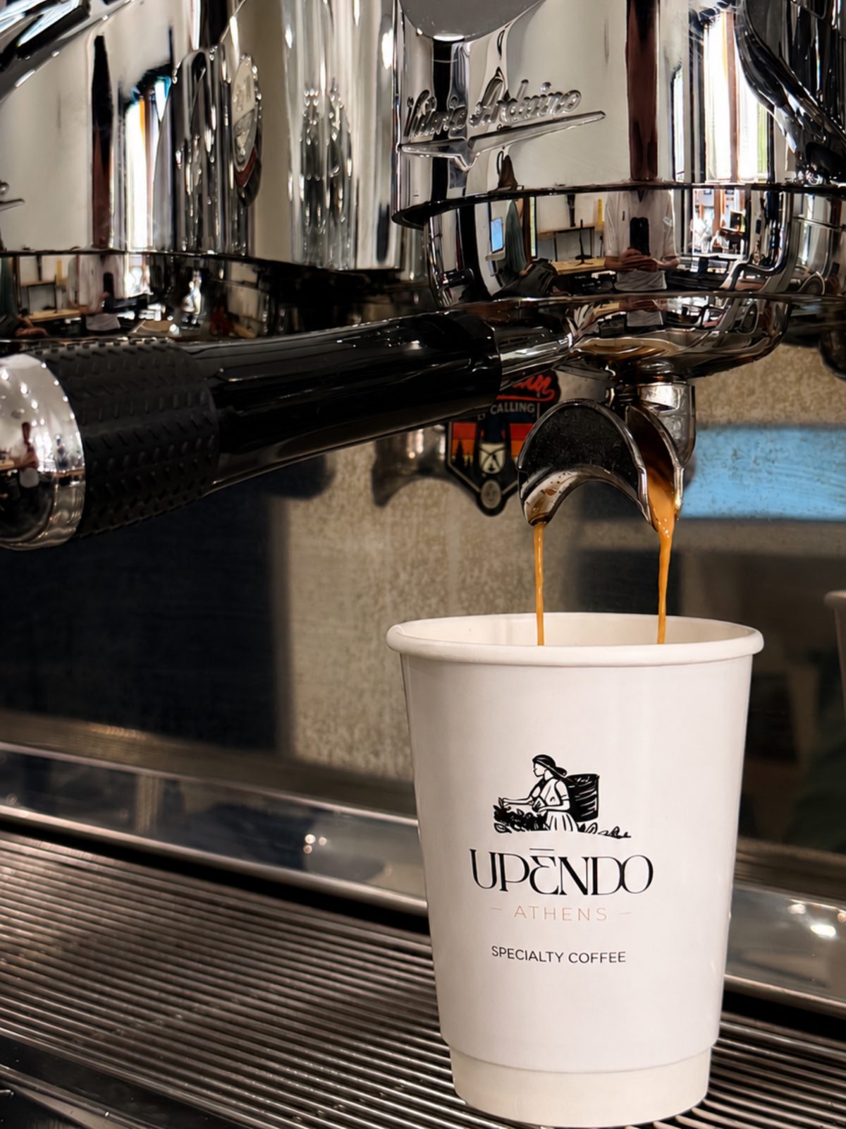 Espresso pouring from the machine into an Upendo cup.